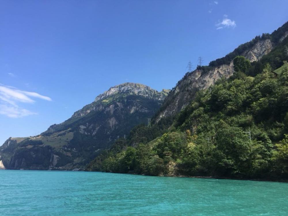 Turquoise water of Lake Uri below steep forested mountains