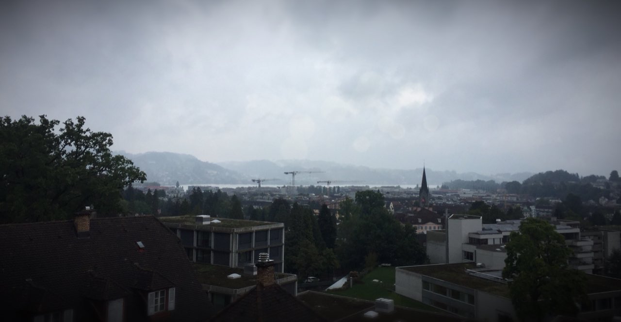 View over the rooftops of Lucerne toward the lake on a misty day